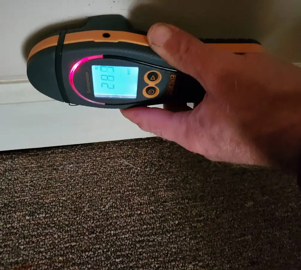 Moisture detection at baseboard during Storm Damage Restoration in Summit